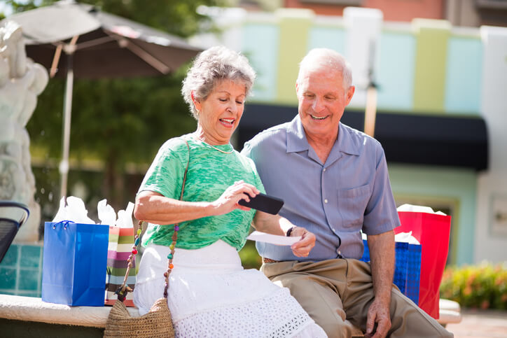 Elderly couple using mobile deposit