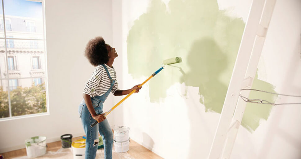 Woman painting wall