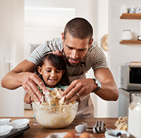 Father and Daughter cooking in kitchen.